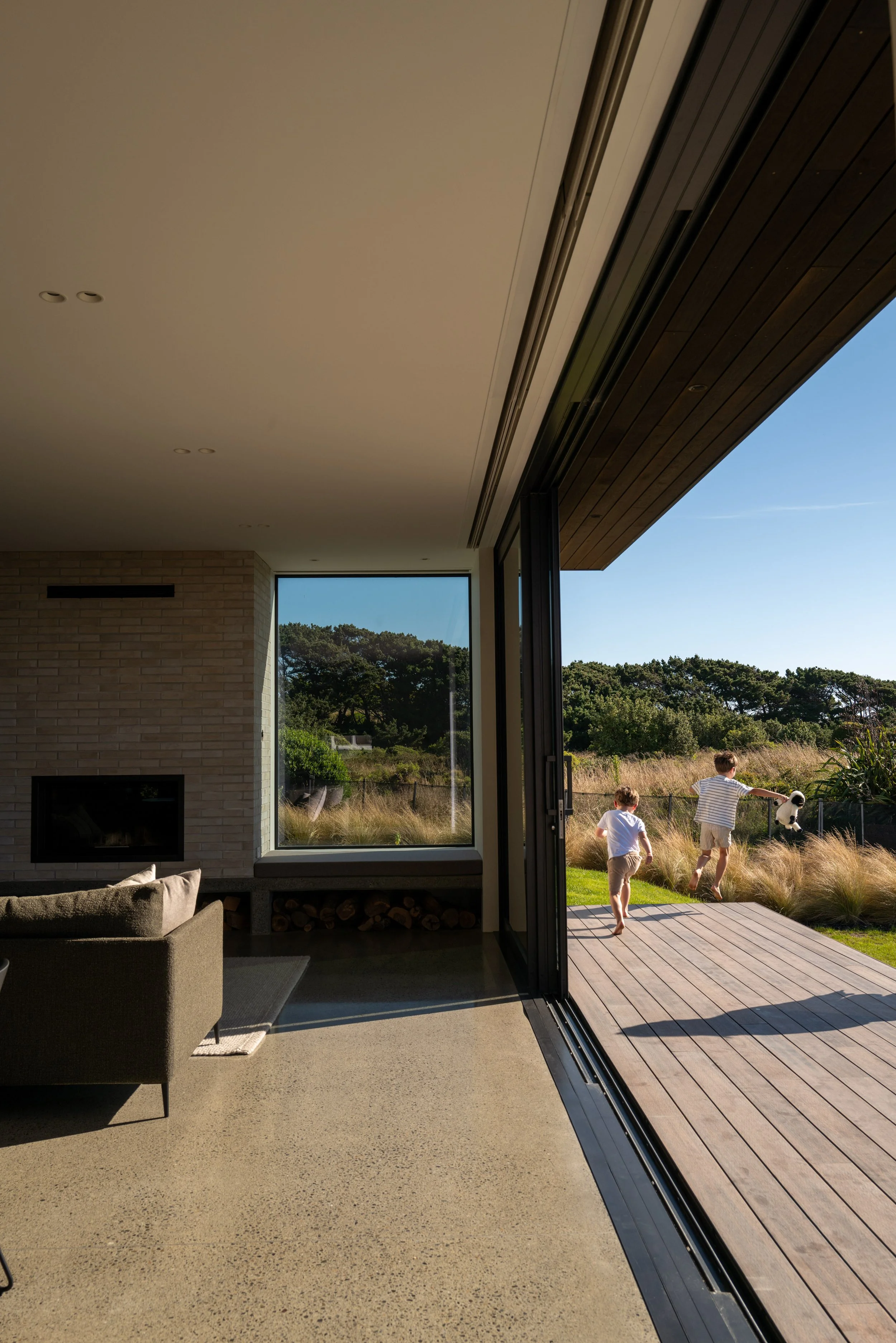 Dining area opening to outdoor living at modern beach house