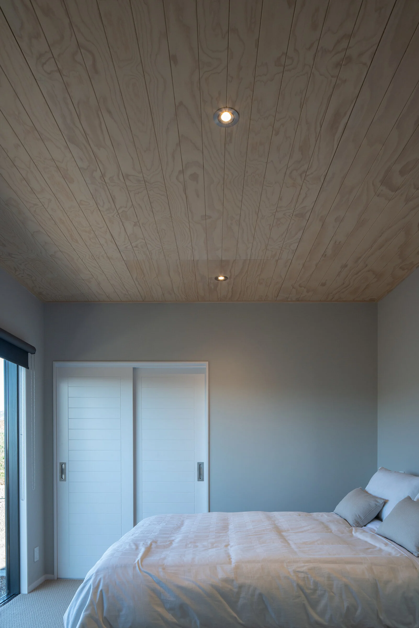 First Light Studio coastal bedroom designed as a quiet private retreat