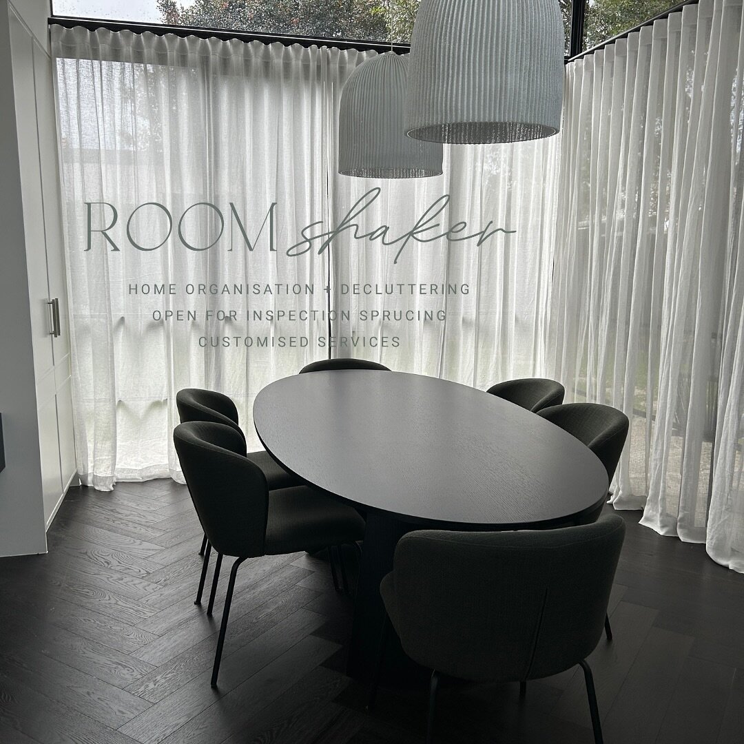 My fantastic client curated the design for her new home, and here's the completed look for her dining room. The ambiance is moody, featuring sheer curtains and dark herringbone floorboards, crafting a sophisticated and dramatic setting. The textured 