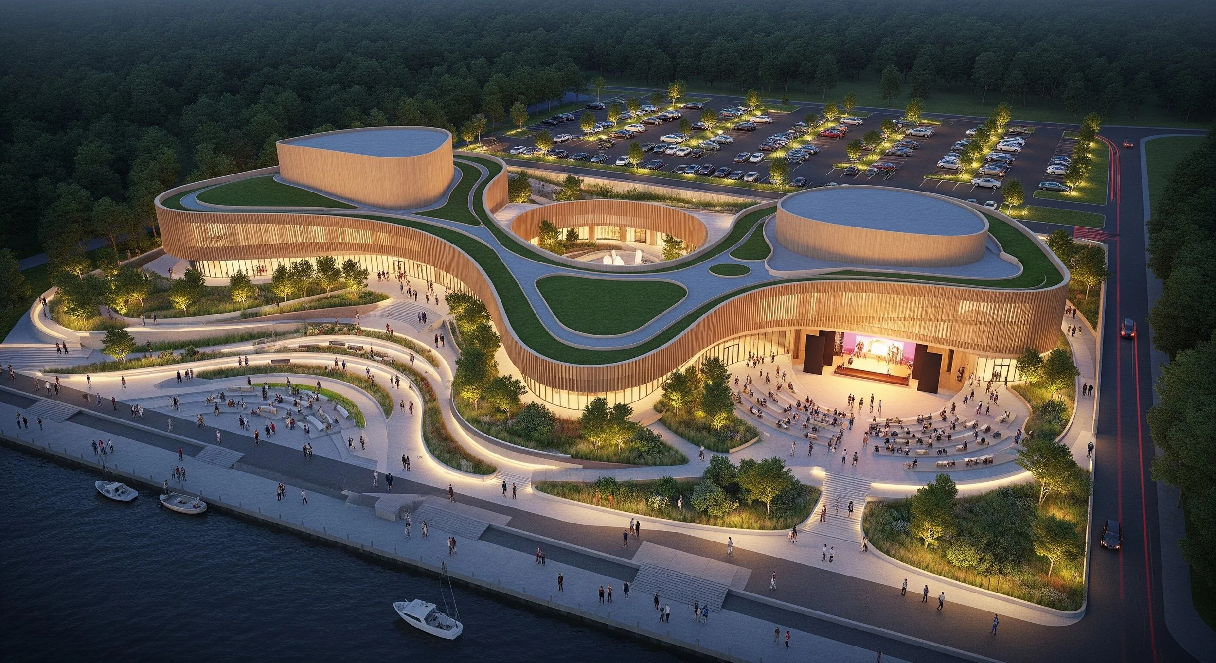 A modern architectural building with curved design and green rooftops, located near water with boats, illuminated by outdoor lighting during evening.