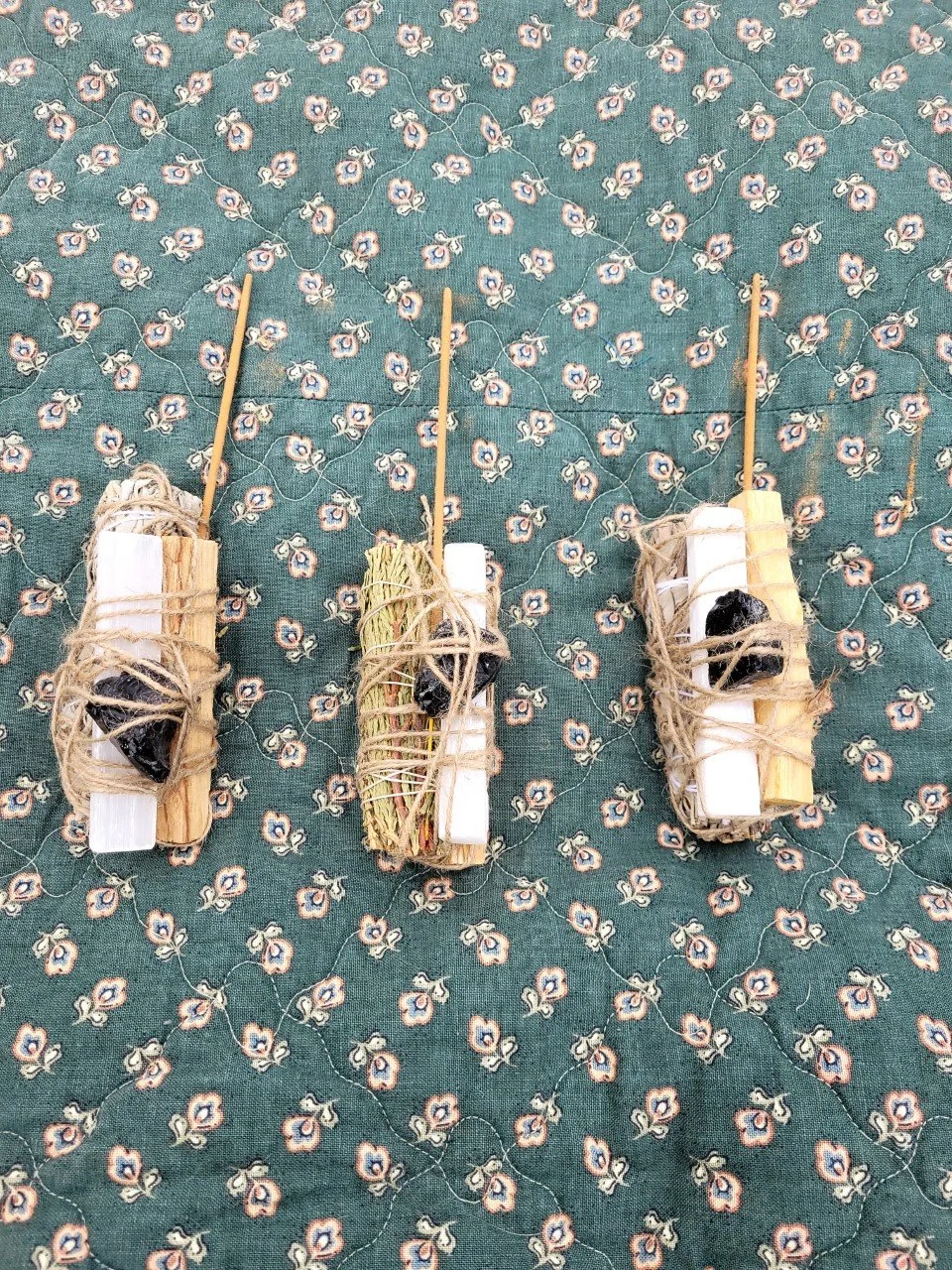 Protection Bundles include white sage or cedar smudge stick with obsidian stone, selenite wand, Palo Santo stick and root chakra incense stick for grounding