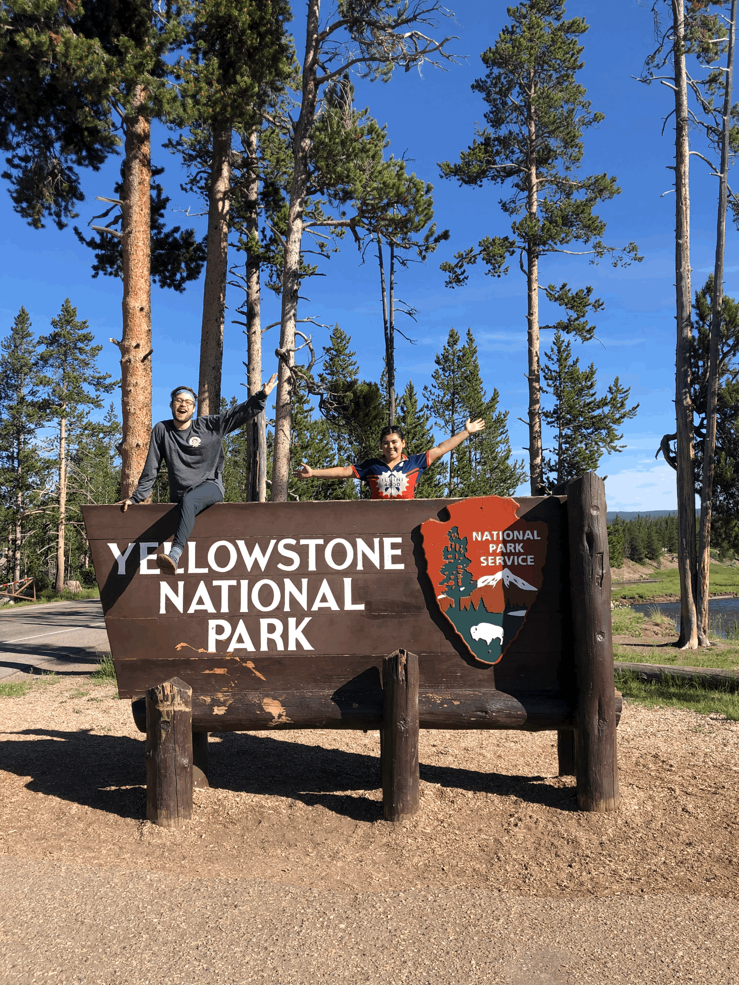 Jumping on top of Yellowstone National Park Entrance Sign
