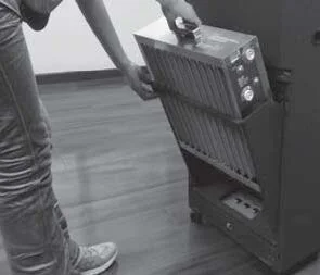 Lifting the electronic cell out of a RespirAide or RPS 600S air purifier by its handle