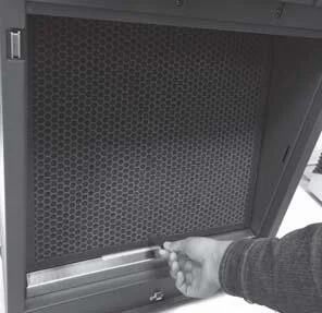 Unhooking the activated carbon filter by its tab on an RPS 600SL air purifier