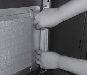 Holding a UV lamp by its ends at the side of the Photocatalytic chamber
