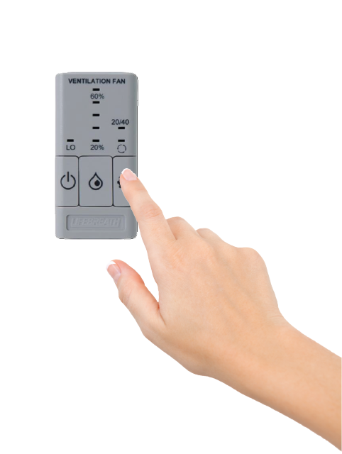 A finger pressing the Platinum ERV wall control, which shows the fan speed and 20/40 run mode settings