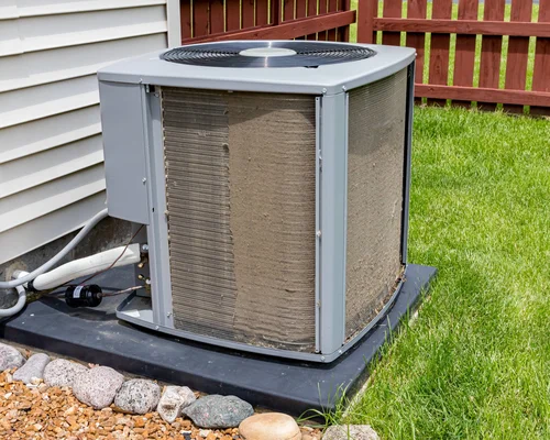 Outdoor air conditioner unit with dirt clogging its coil fins