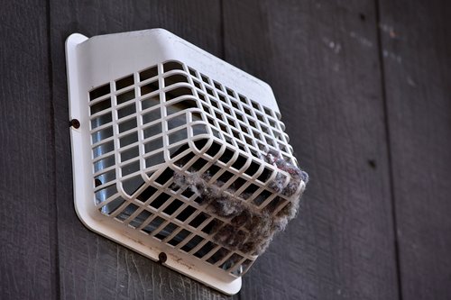 Exterior dryer exhaust vent cover clogged with lint