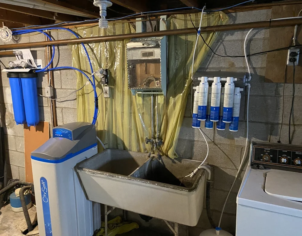 Basement with a CitySoft water conditioner and a 7-stage drinking water system on the wall, installed by Platinum Air Care