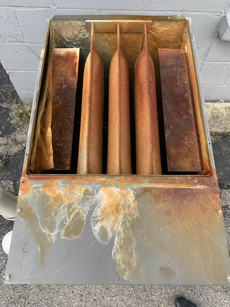Rust and corrosion inside the same old furnace, seen from above