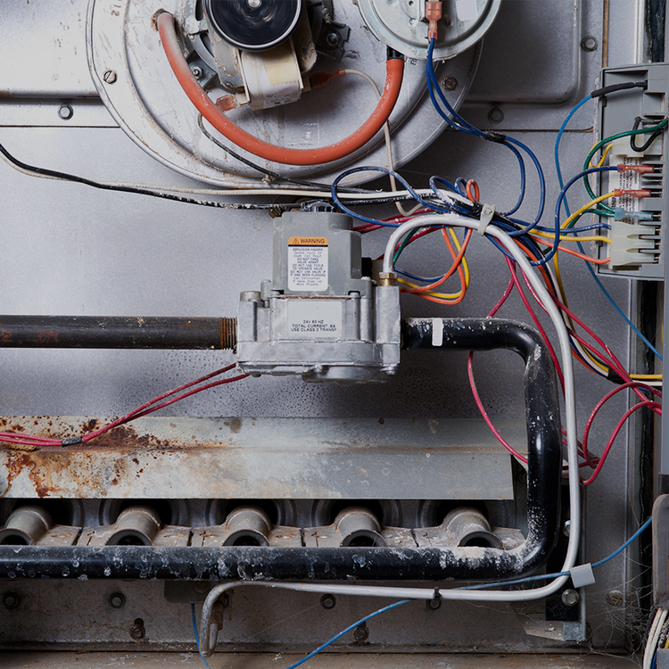 Inside a gas furnace: the gas valve, burner tubes, and control wiring