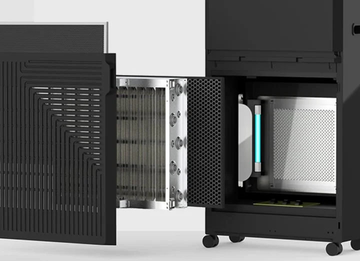 RPS 600S with its front panel off and the electronic cell and carbon filter pulled out, showing the lit UV lamp in the chamber behind them
