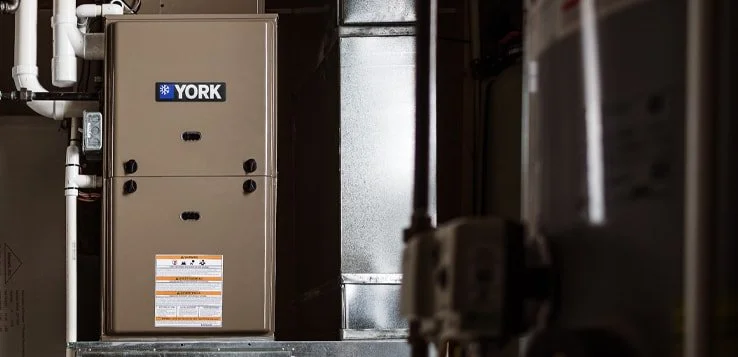 York gas furnace installed in a basement, the York badge on its cabinet door