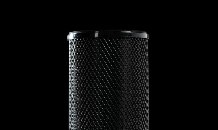 The MedicAir's black activated nano carbon filter cylinder on a black background