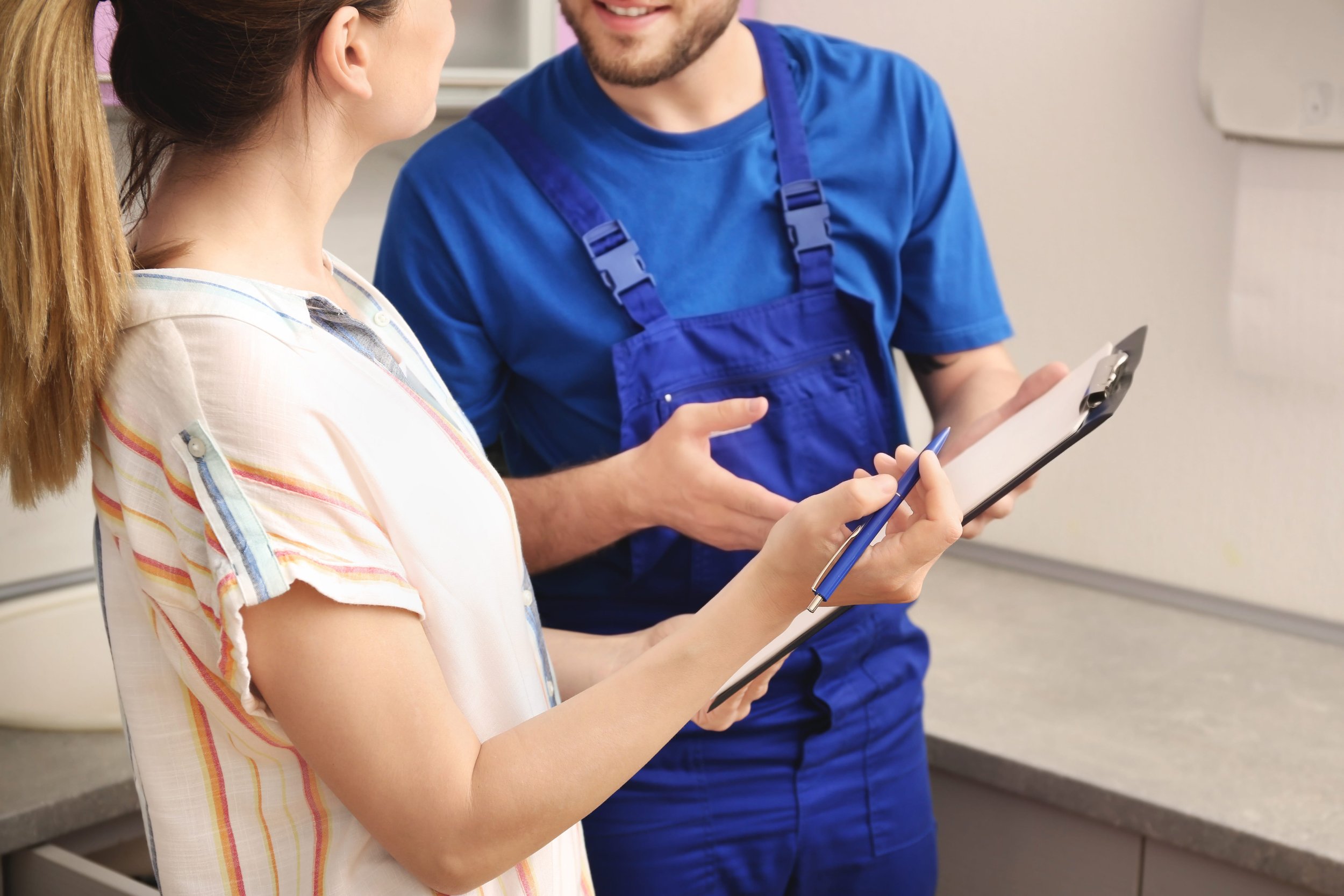 technician-explaining-workorder-to-female-customer