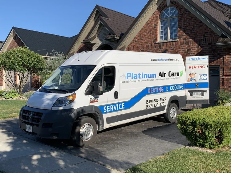 Platinum Air Care heating and cooling service van parked in front of a brick house in London, Ontario