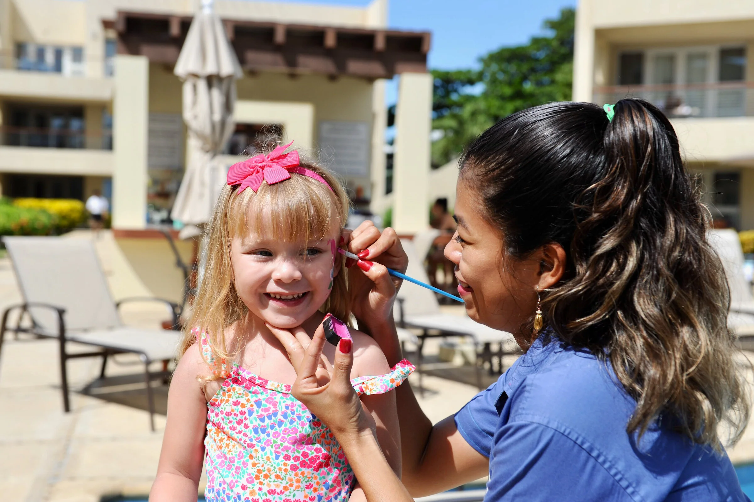 Childrens face painting at The Phoenix Nest, a complimentary kids club at our San Pedro resort.
