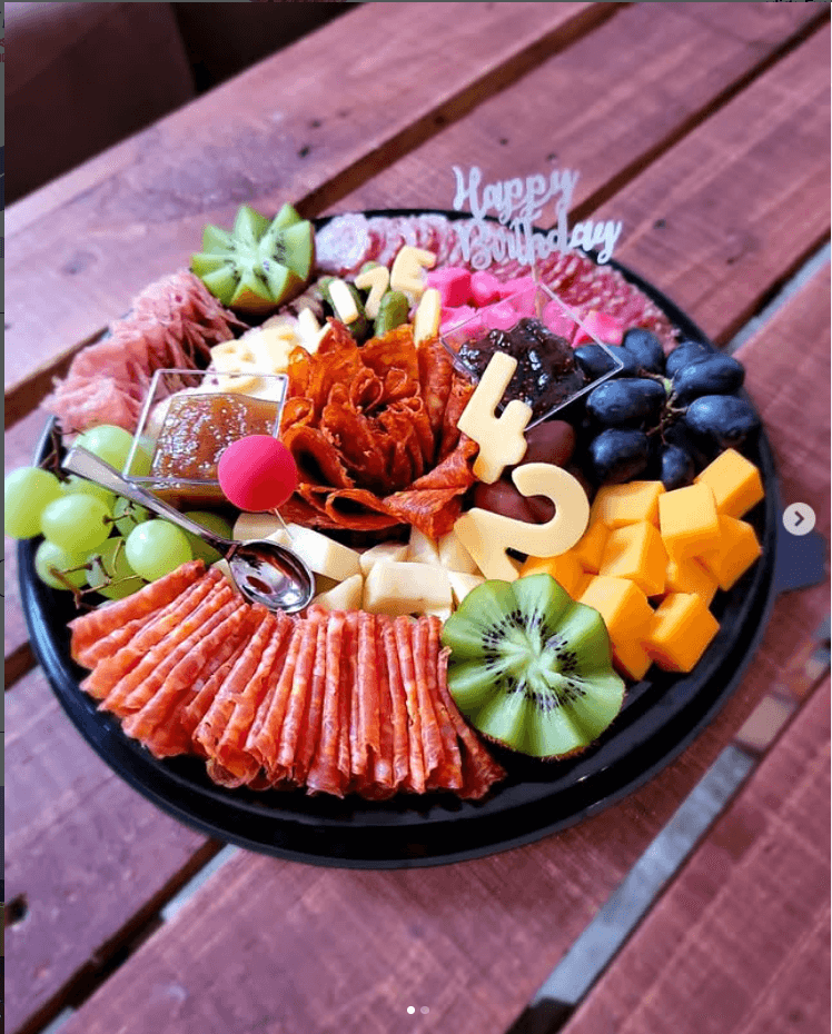 A gourmet charcuterie board with imported cheeses, meats, and olives at Wine de Vine, the premier wine shop in San Pedro, Belize.