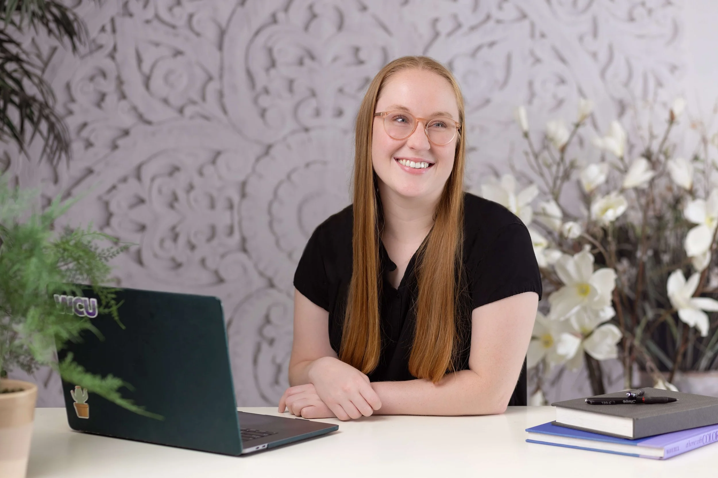 bonnie smiling away from laptop because she gave her clients a peaceful workflow