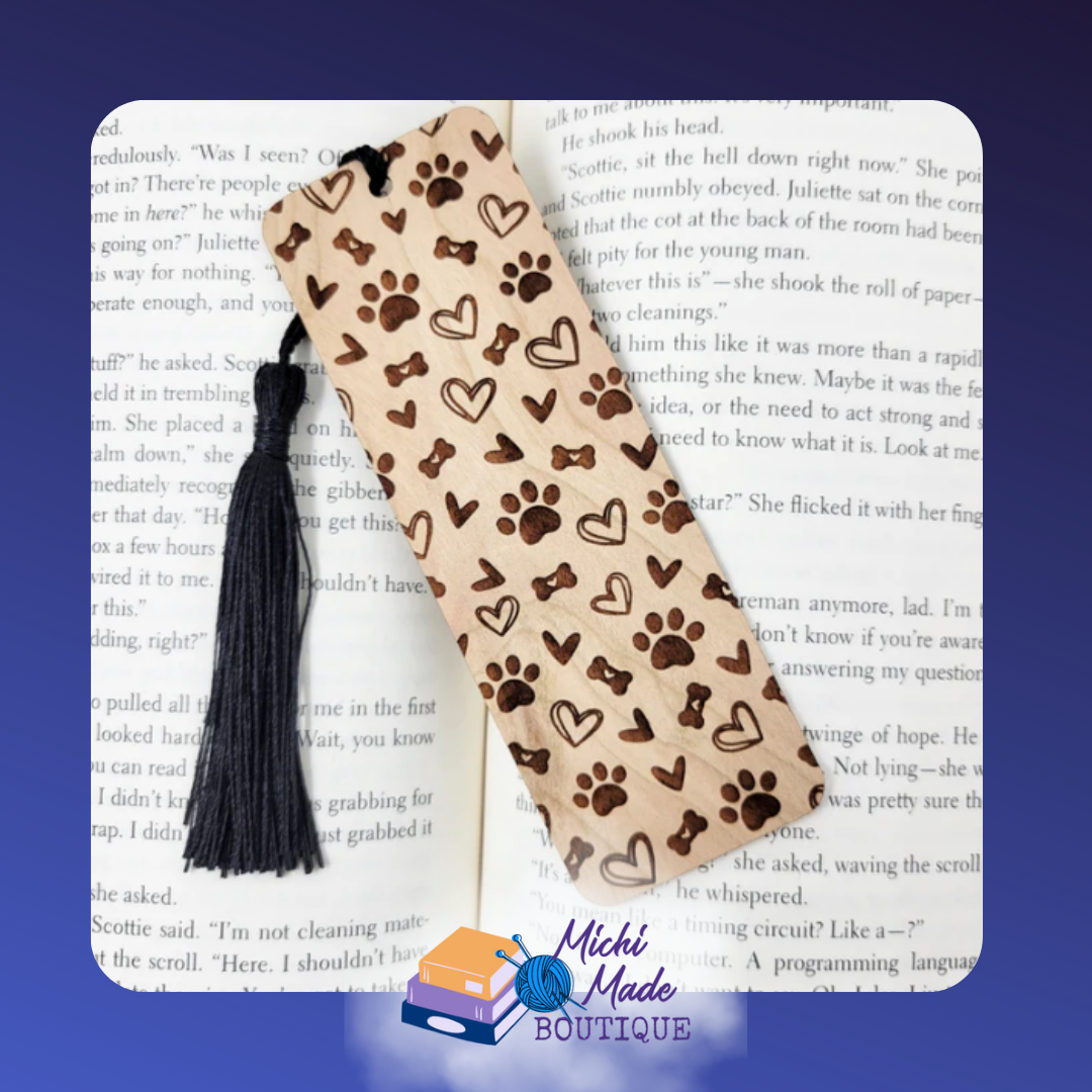 Dog Lover Bookmark – Wooden bookmark engraved with dog paw prints, bones, and hearts, with a black tassel.