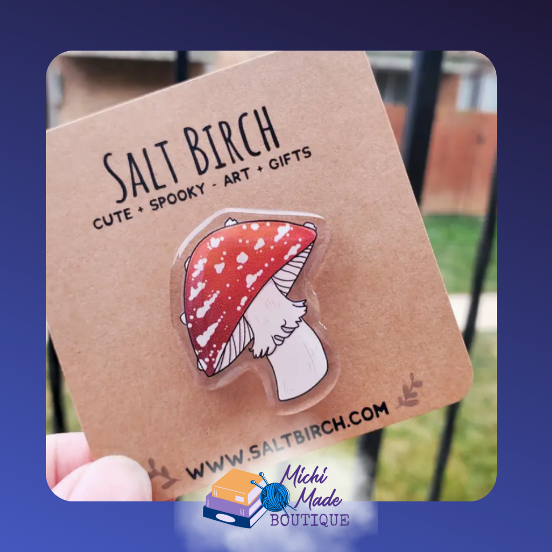 Acrylic pin of red and white mushroom cap.