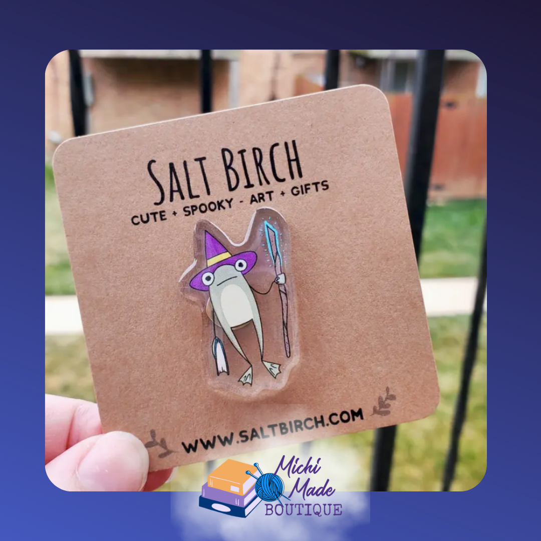 Acrylic pin of wizard frog in purple hat holding staff.