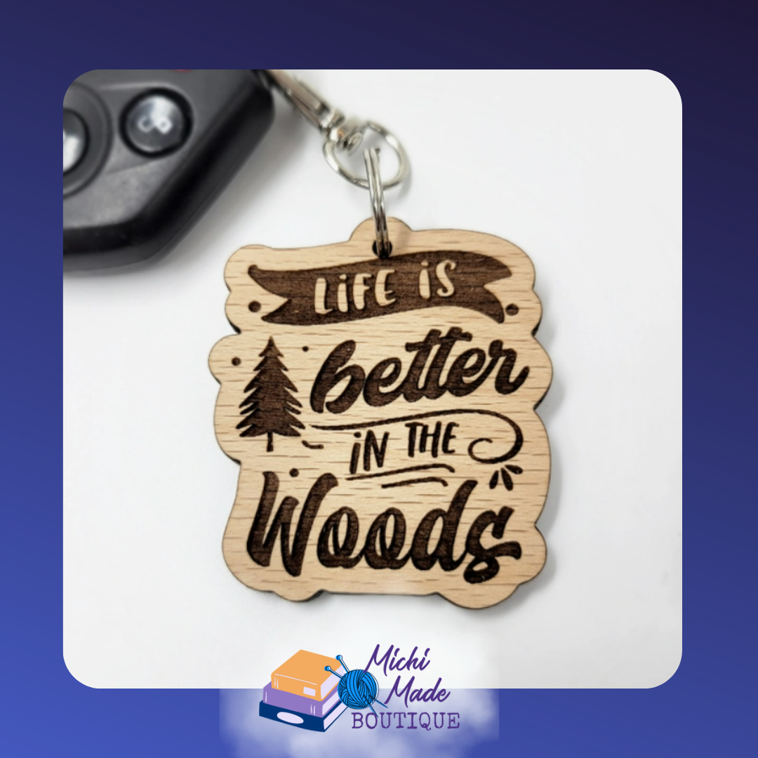 Wooden keychain etched with “Life is better in the woods” and forest details.