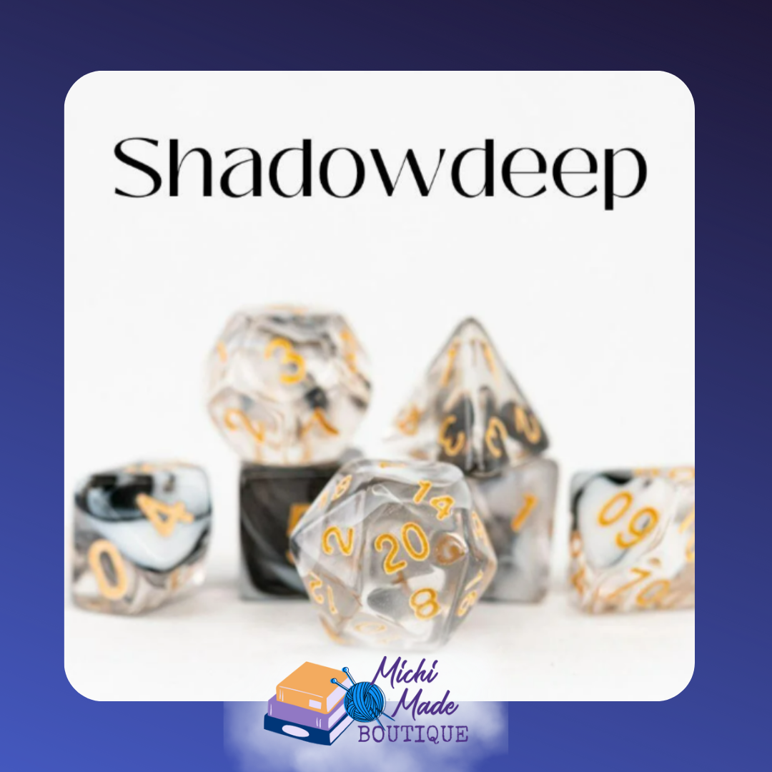 Shadowdeep: “Black, white, and clear marbled acrylic dice with gold numerals.”