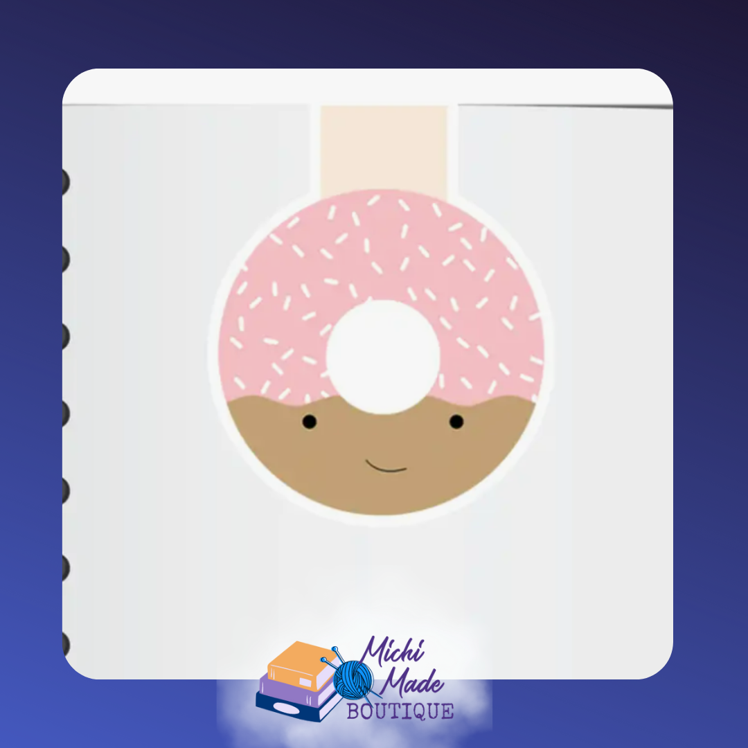 Donut-shaped magnetic bookmark with pink frosting, sprinkles, and a happy smiling face.