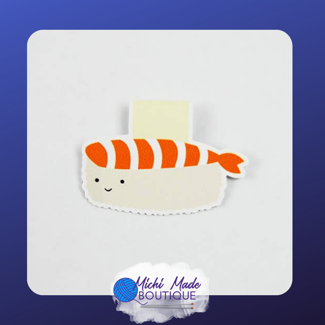 A happy salmon nigiri sushi bookmark with a smiling face and a cream background.
