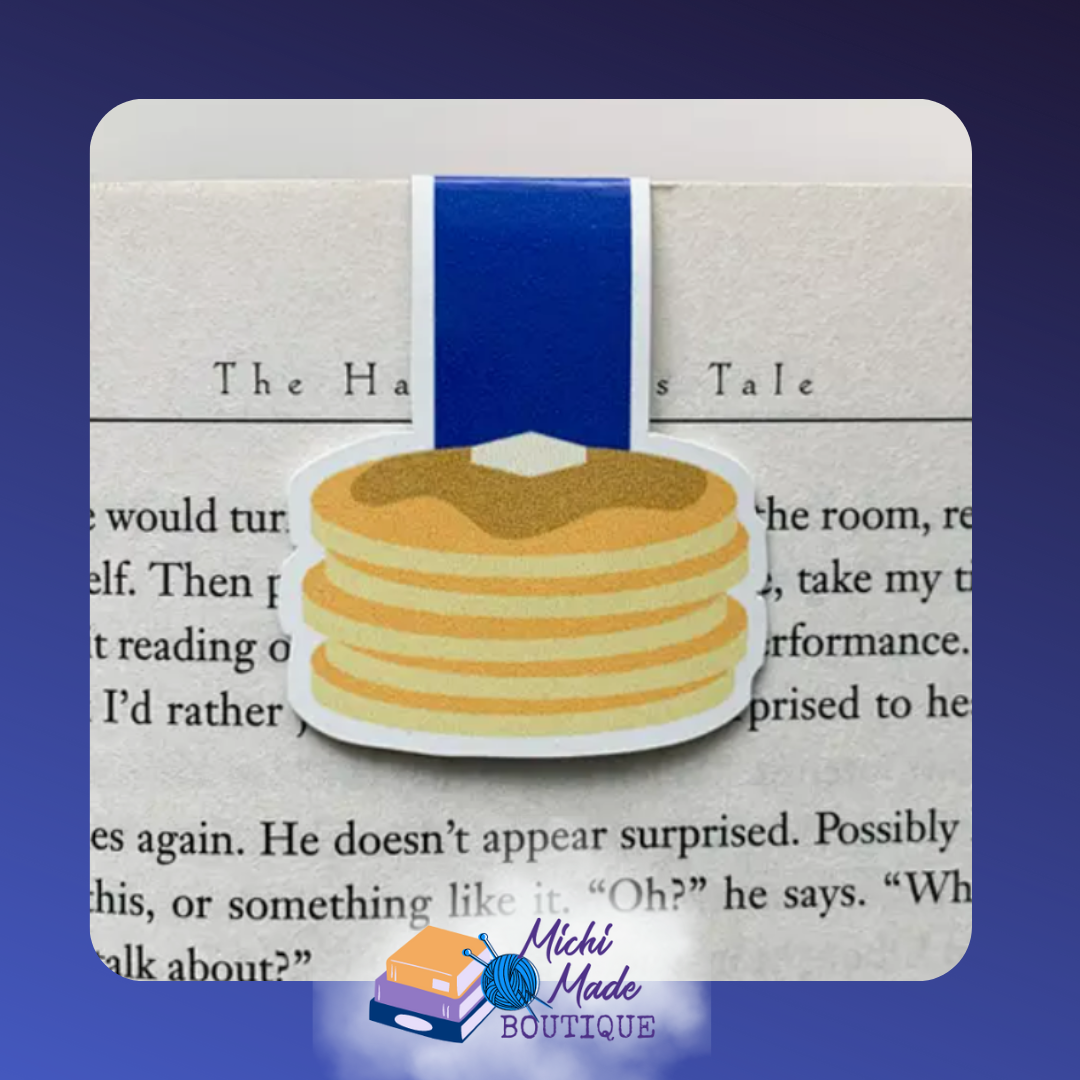 Fluffy stack of pancakes with butter on top and a navy strap, used as a bookmark