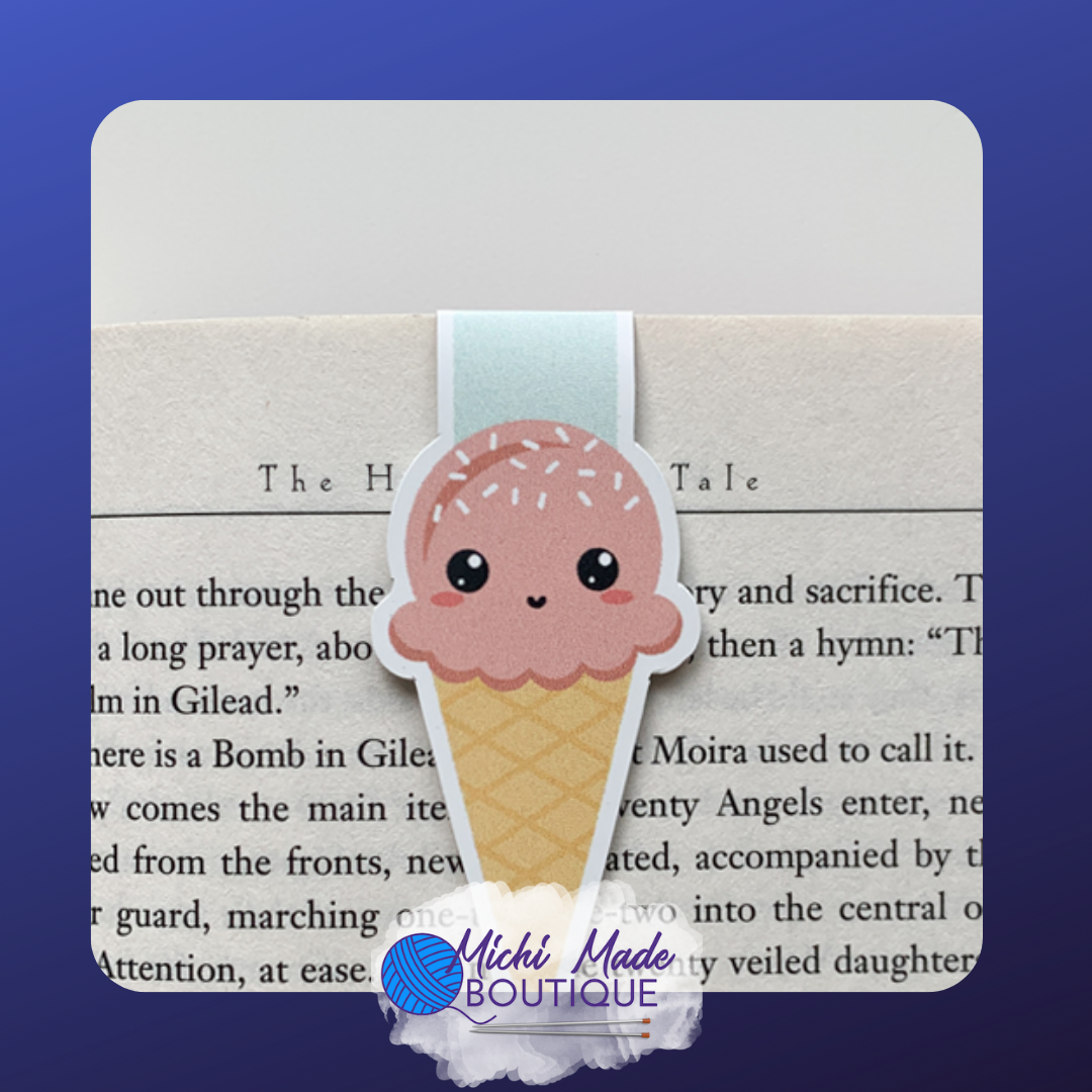 Smiling pink ice cream cone bookmark with sprinkles and a light blue strap.