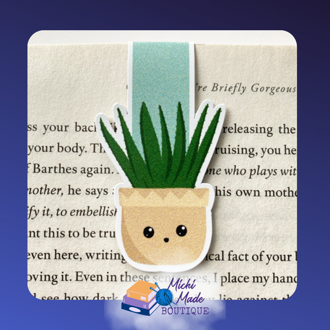 Astronaut-shaped magnetic bookmark holding a page, featuring a white suit and dark visor.