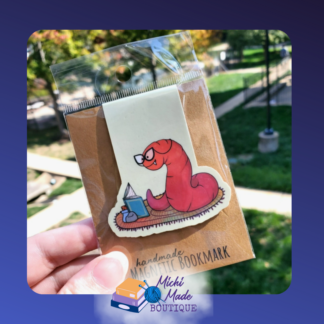 Cute red worm with glasses inside a red book.
