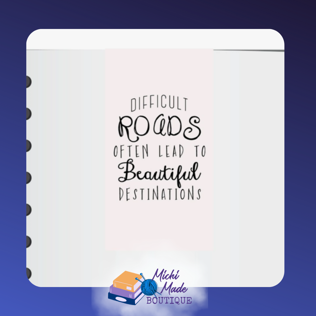Magnetic bookmark with black text: “Difficult roads often lead to beautiful destinations.”