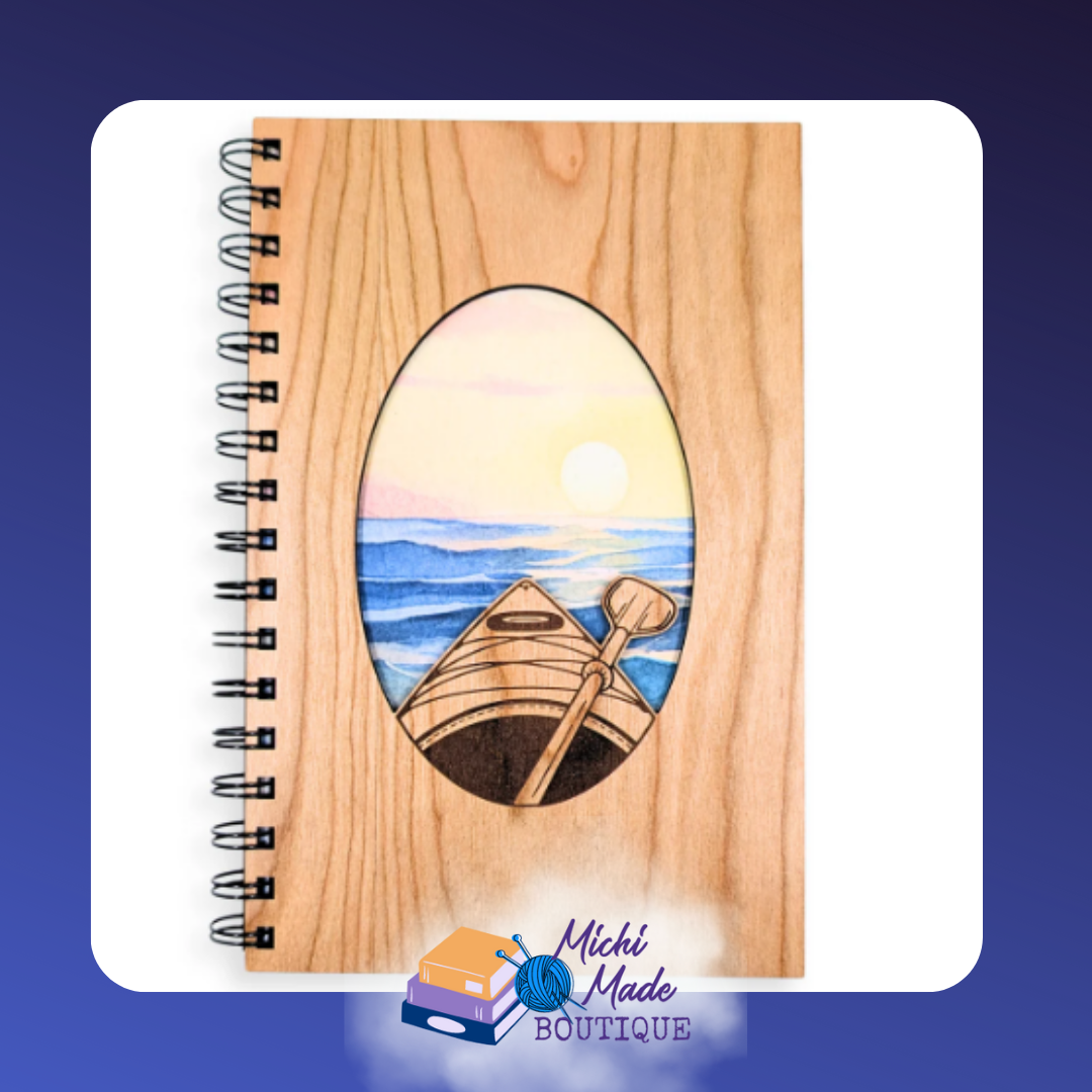Kayaking - Wooden journal with engraved oval window revealing a colorful sunset kayaking scene.