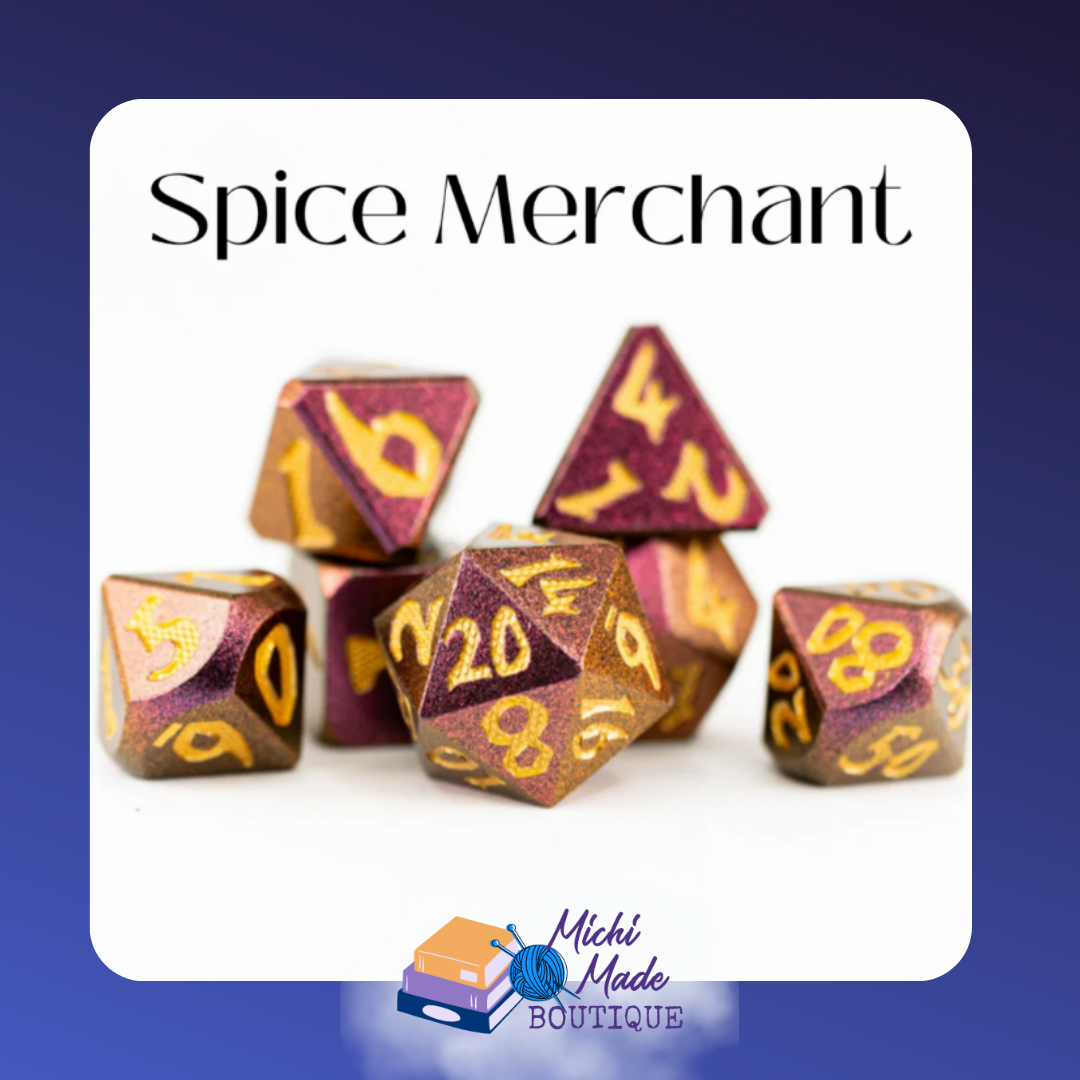 “Close-up of the Spice Merchant metal dice set featuring large-print golden numbers on metallic mauve and bronze faces.”