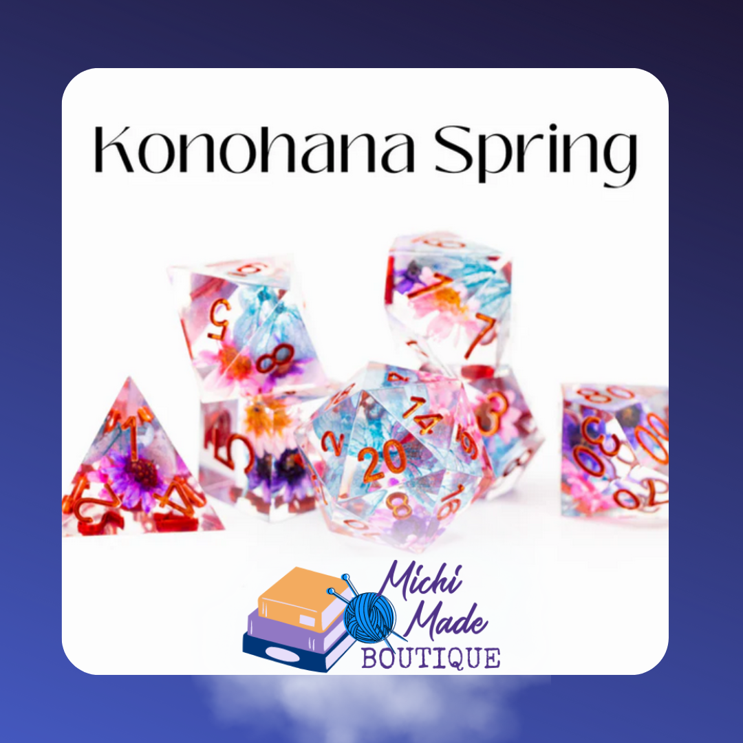 Konohana Spring — Clear resin dice with embedded pressed flowers in pink, blue, and purple, red numbering on white.