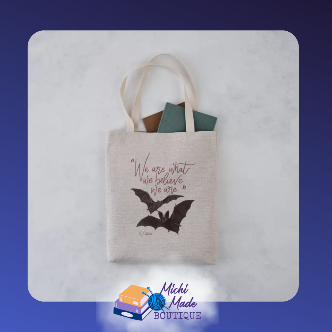 Tote with inspiring text “We Are What We Believe We Are” by CS Lewis printed across the front with bats.