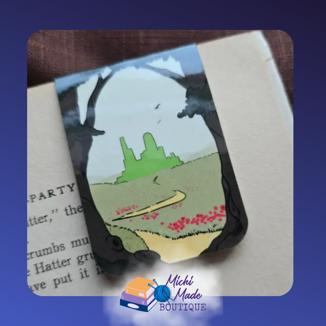 Illustration of Emerald City off in the distance and yellow road leading to it with small red flowers alongside. This is the front of the Emerald City Wizard Bookmark.