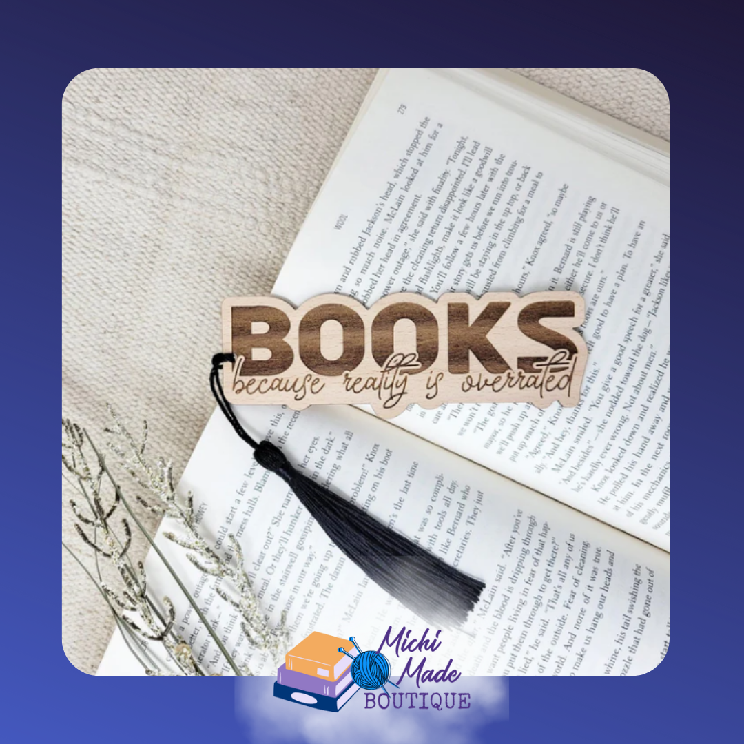 Wooden bookmark engraved with "Books because reality is overrated," with black tassel.