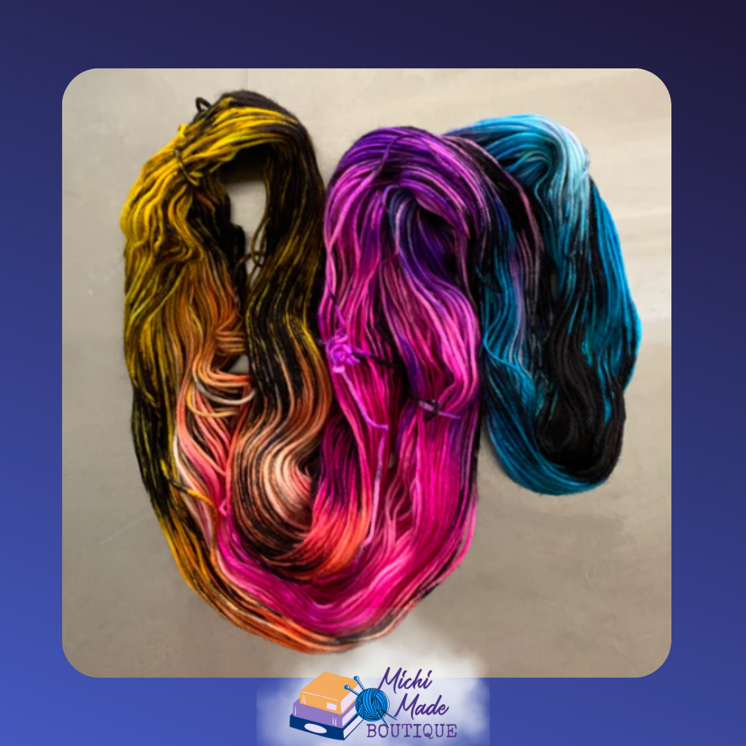 Rainbow in the Dark 2.png — Skein of yarn with transition through colors of rainbow and black mixed in.