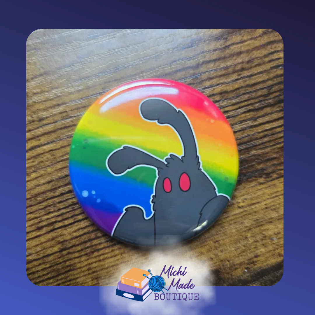 Rainbow Mothman Fridge Magnet – Mothman peeking from the side of a rainbow-striped background.
