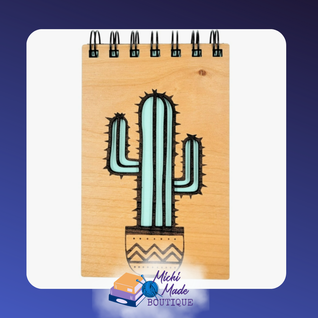 Small wood-cover notepad with engraved tall cactus in a patterned pot.
