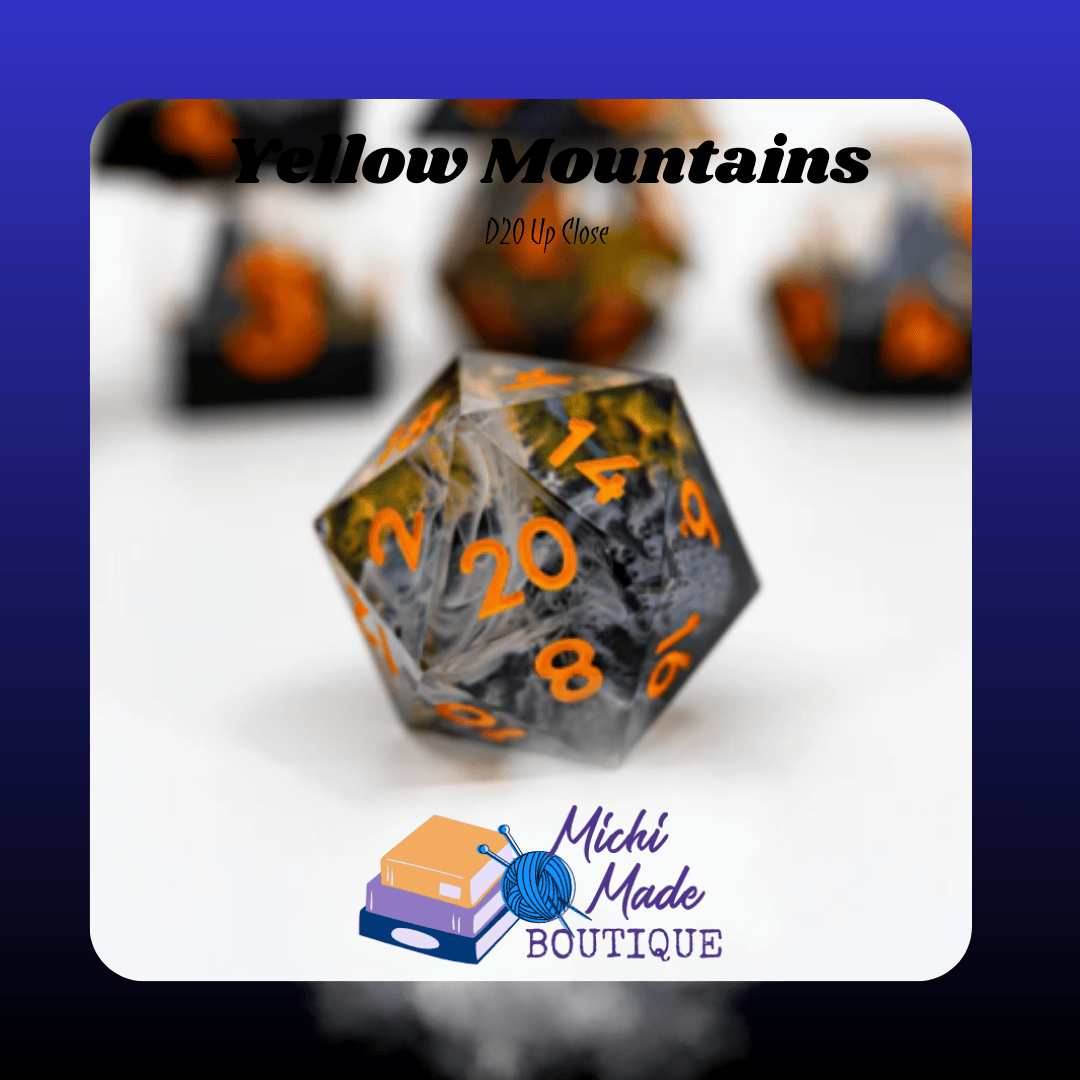 Yellow Mountains – D20 Up Close — Close-up d20 showing gold-gray terrain with orange numerals under clear shell.