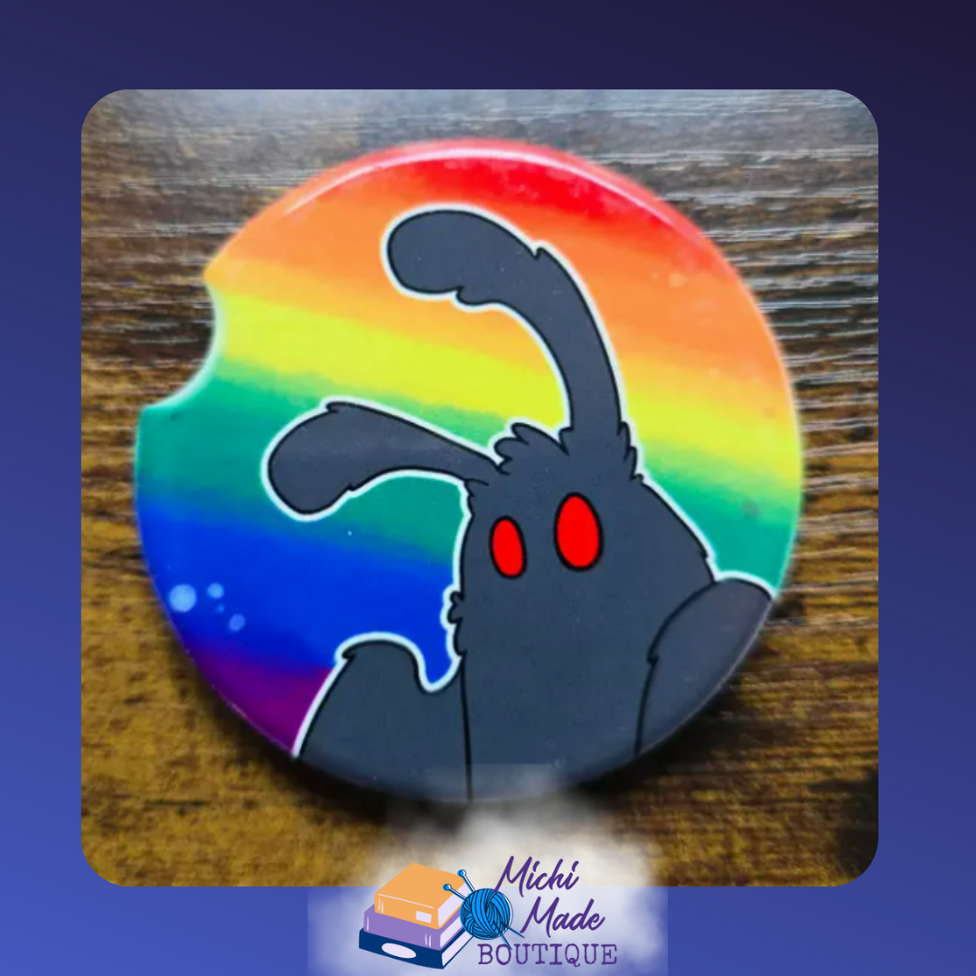 Ceramic car coaster with cartoon Mothman on a rainbow gradient background.