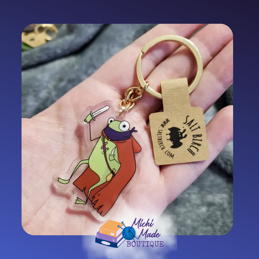 Rogue frog keychain in red cape wielding dagger.