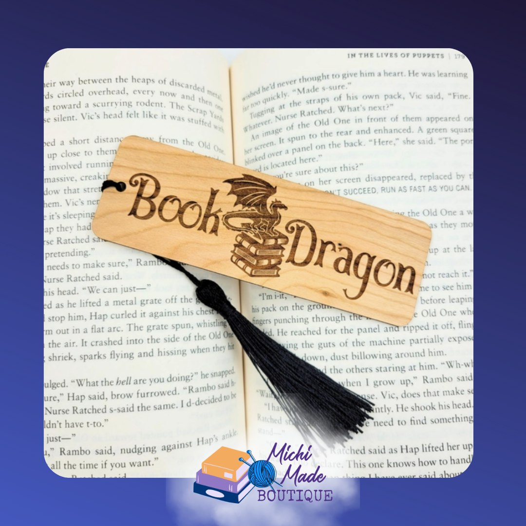 Wood bookmark with "Book Dragon" text and dragon perched on stacked books, with black tassel.