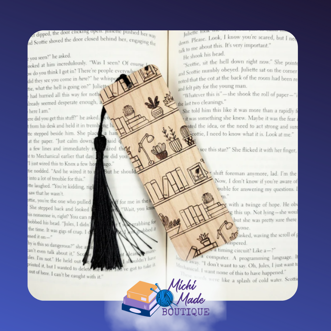 Cozy Bookshelf Bookmark – Wooden bookmark engraved with books, plants, and lamps on shelves, with a black tassel.