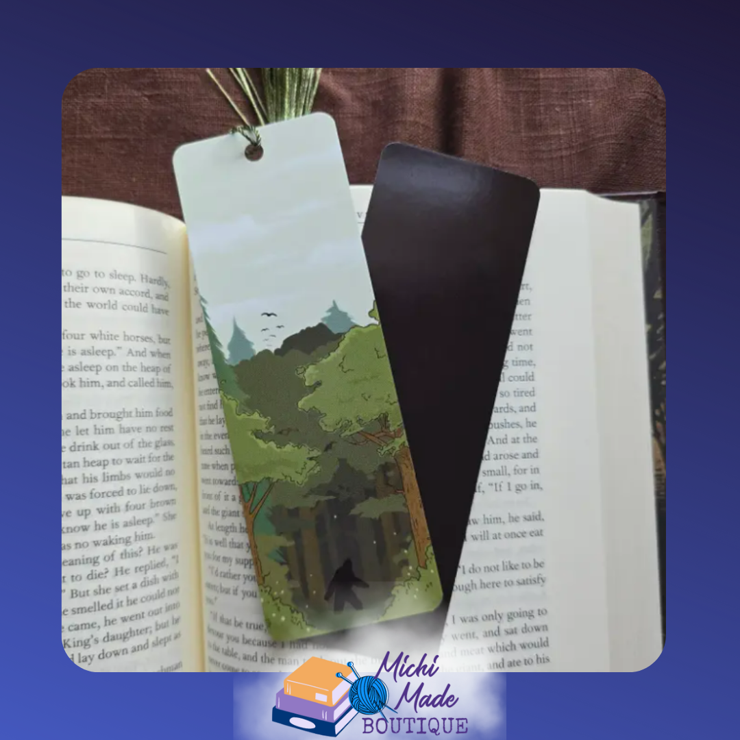 2"x6" bookmark with Bigfoot silhouette in a forest scene, green tassel attached.